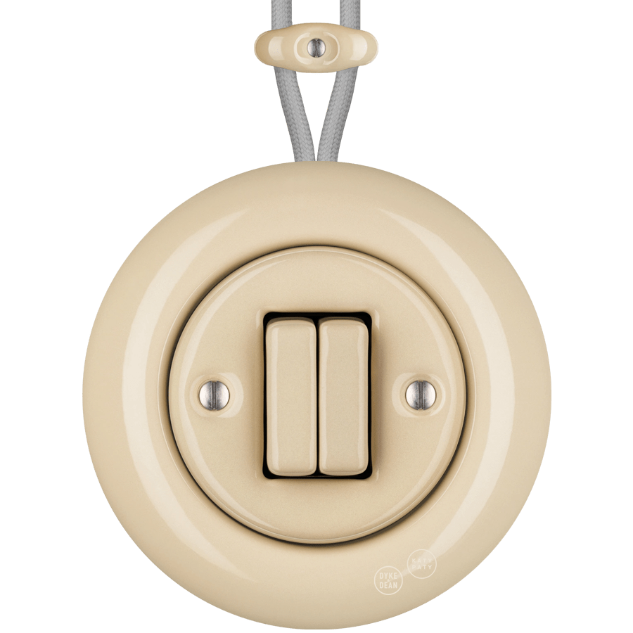 PORCELAIN KATY PATY COLONA ROUND SURFACE MOUNTED DOUBLE SLIM BUTTON SWITCH SAND - DYKE & DEAN