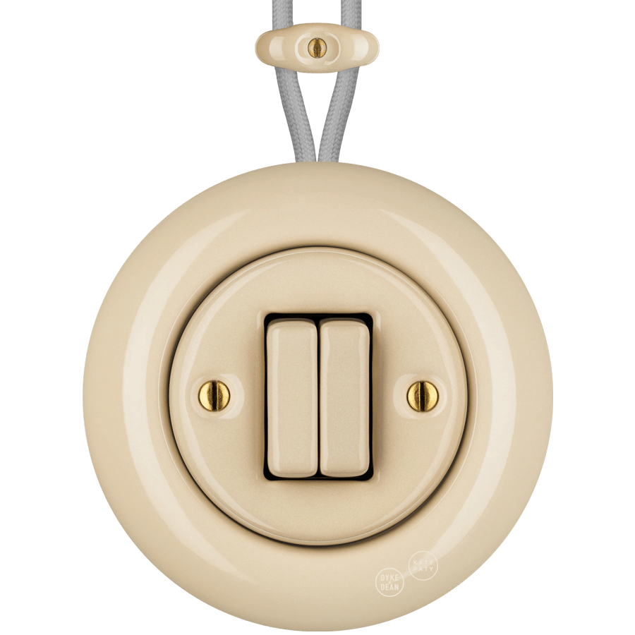 PORCELAIN KATY PATY COLONA ROUND SURFACE MOUNTED DOUBLE SLIM BUTTON SWITCH SAND - DYKE & DEAN