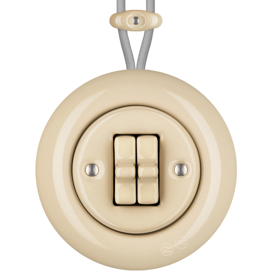 PORCELAIN KATY PATY COLONA ROUND SURFACE MOUNTED DOUBLE TOGGLE BUTTON SWITCH SAND - DYKE & DEAN